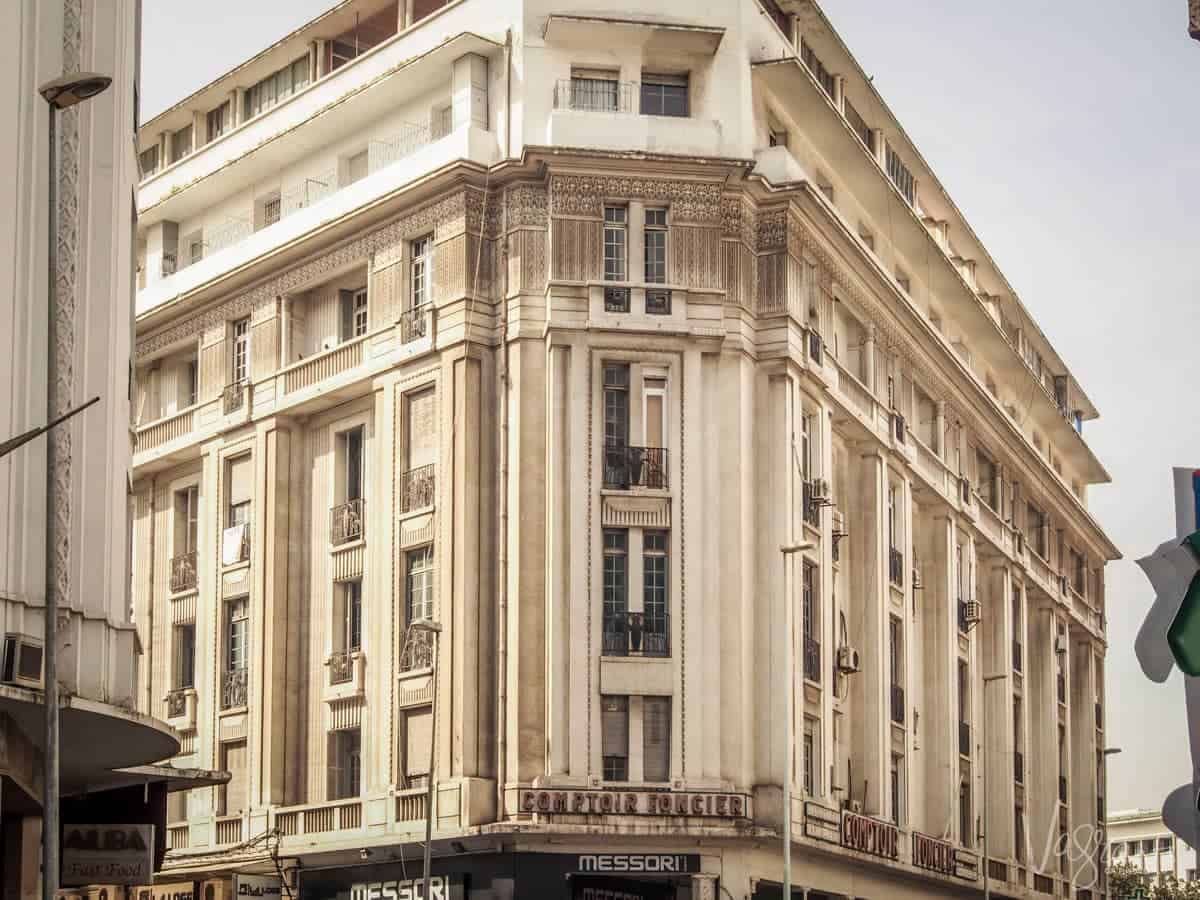 The corner of a multi-story building in Casablanca with French architecture features
