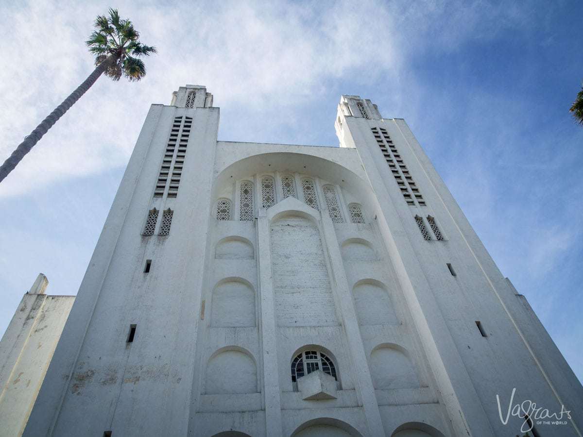 An angled view looking up at the towers of Sacre Coeur Cathedral in Casablanca.
