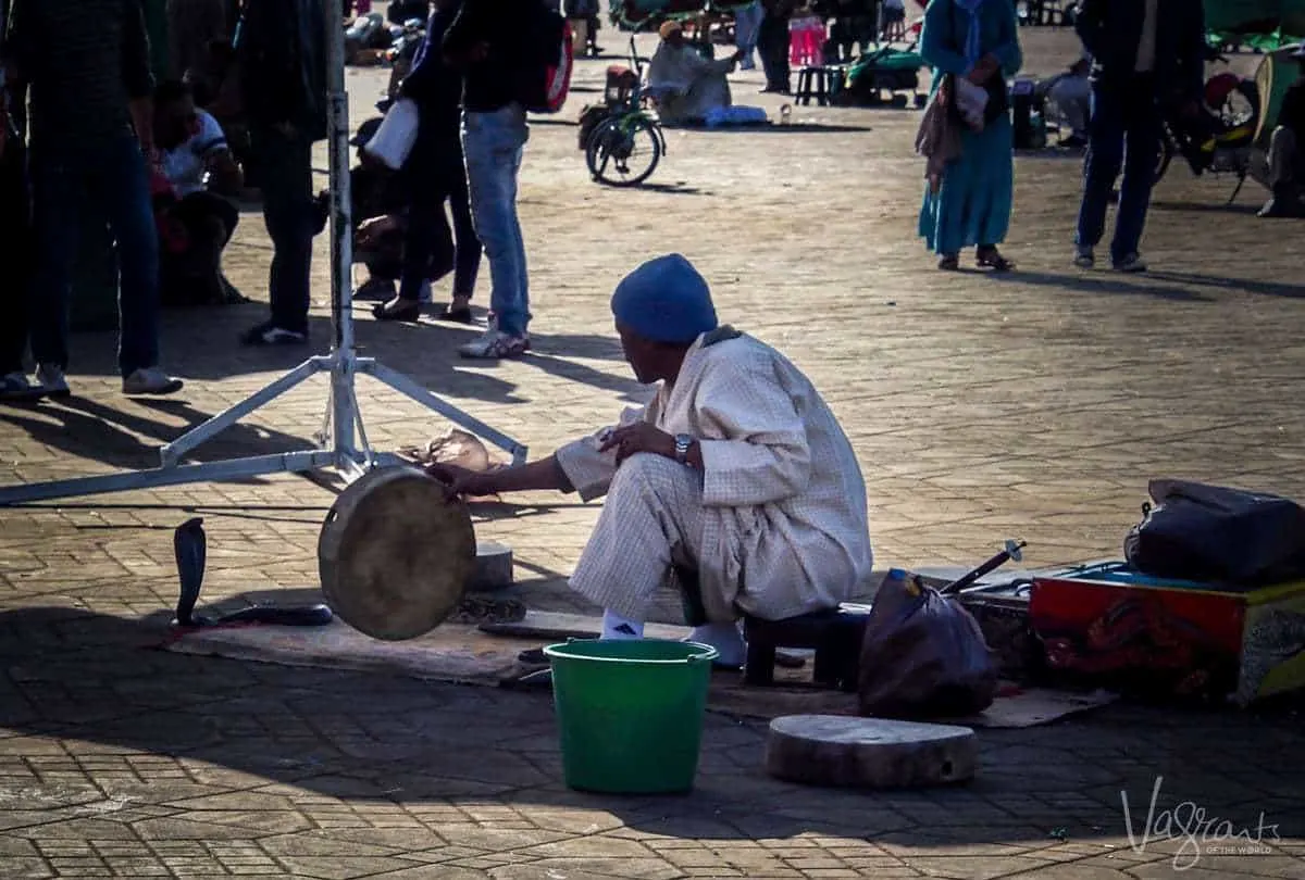 Snake charmer at Jemaa el-Fna Marrakech Morocco. Is Morrocco safe. Beware of pickpockets in Marrakesh. Beware of scammers in Marrakesh.