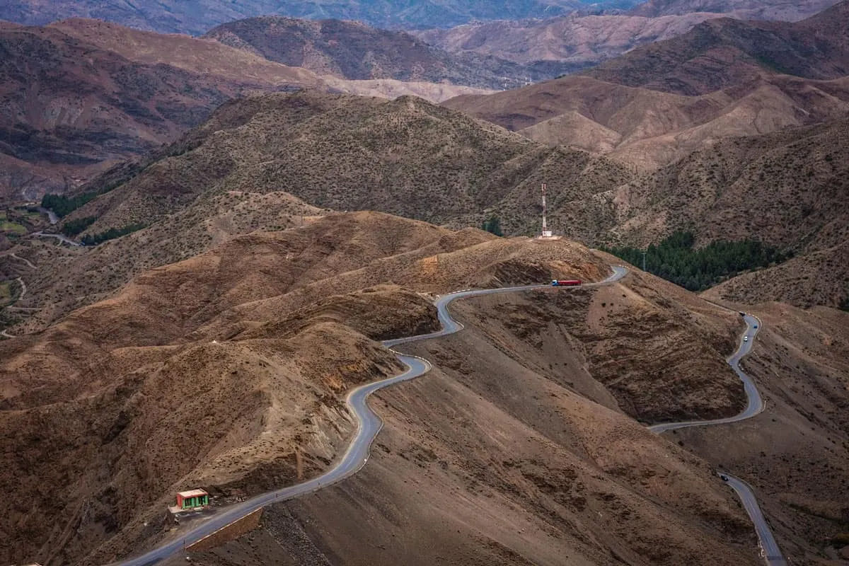 Moroccan road trip Marrakech to Fez Crossing the high Atlas Mountains along a windy road which sits atop the mountain ridges.