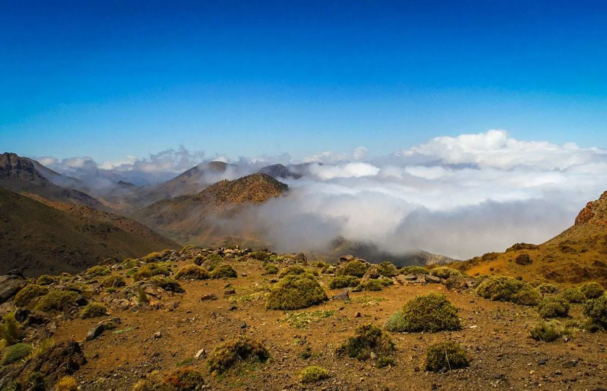 morocco road trip Marrakech to Fez Crossing the high Atlas Mountains with low cloud hovering over the mountain tops.