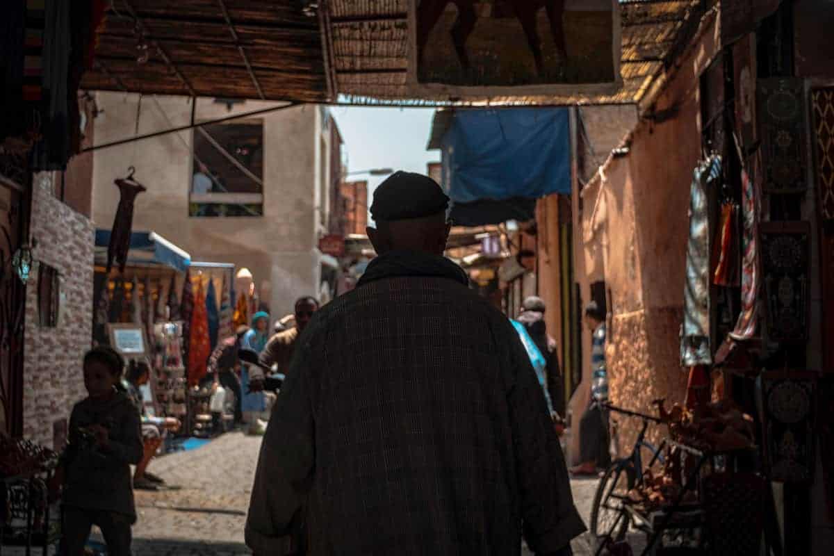 dark back of man in Marrakech Medina morocco. Is Morrocco safe. Beware of pickpockets in Marrakesh