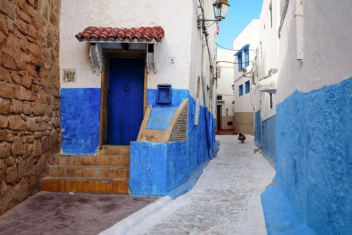 Street scene with blue and white wall in Chefchaouen Morocco