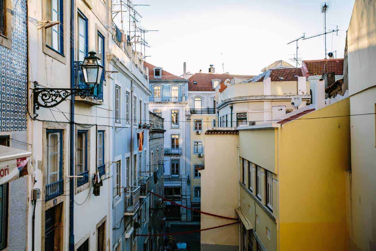 Typical Lisbon apartment buildings in Alfama and ornamental lights. 