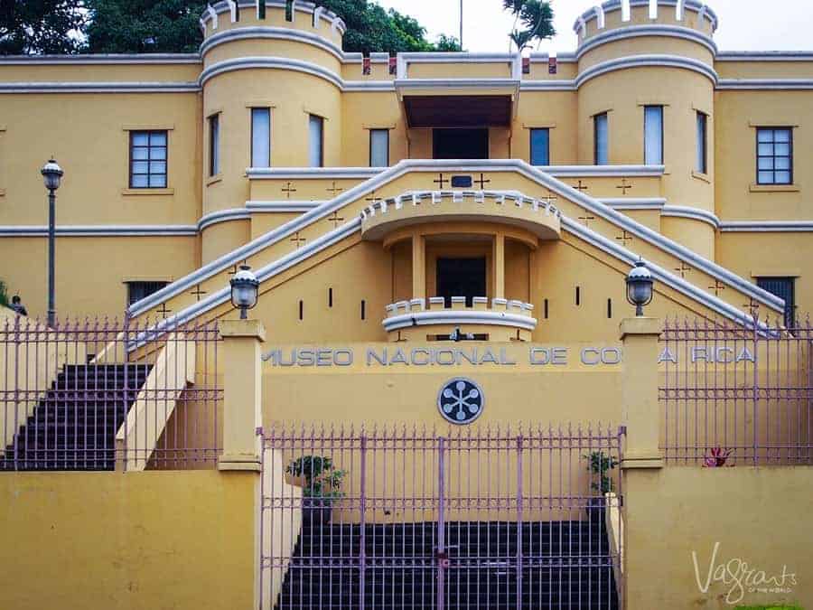 The yellow building housing the National Museum of Costa Rica. 