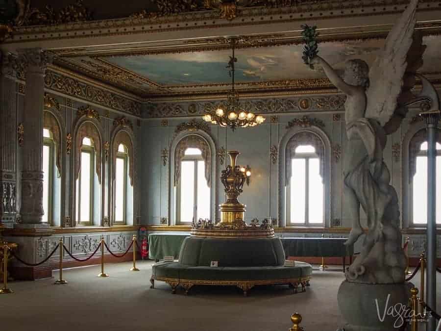 The gilded interior of the National Theatre San Jose Costa Rica with chandeliers and statues. 