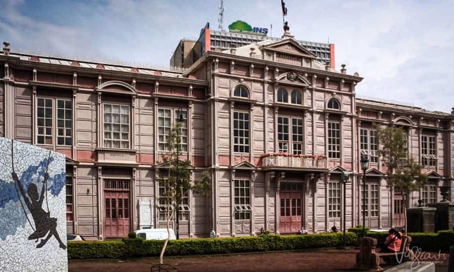 A historical building made with pressed metal in a pink hue in San Jose. 