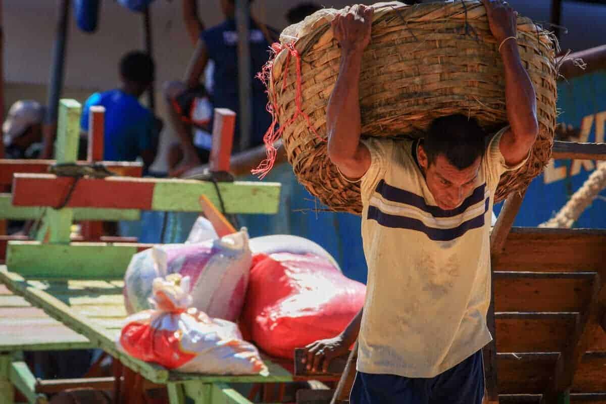 man carrying basket on his back