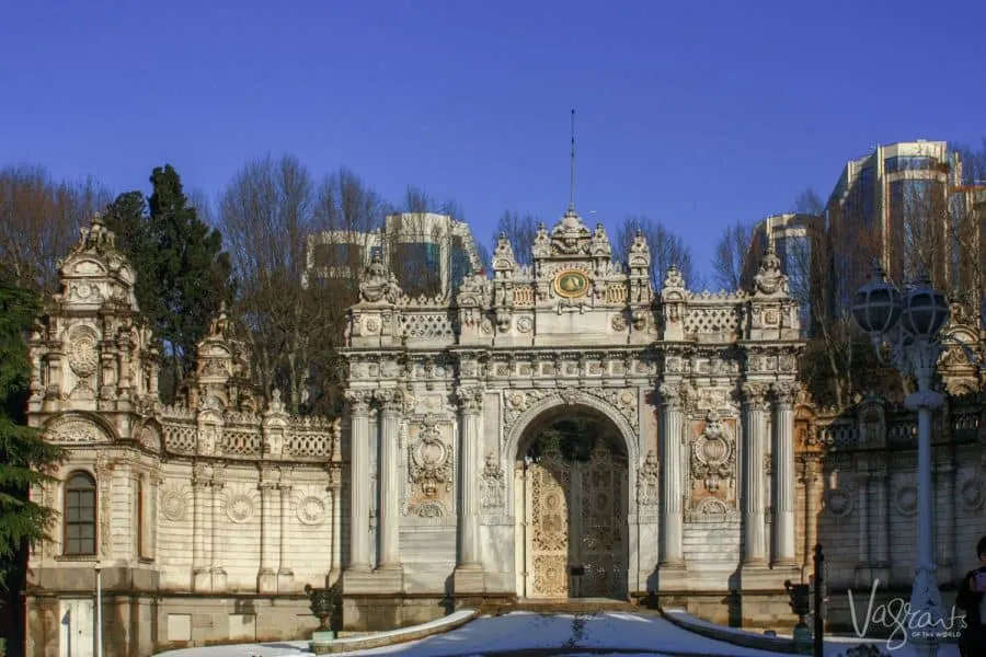 Exterior of the Dolmabahçe Palace on a clear winters day. There is snow on the ground. 