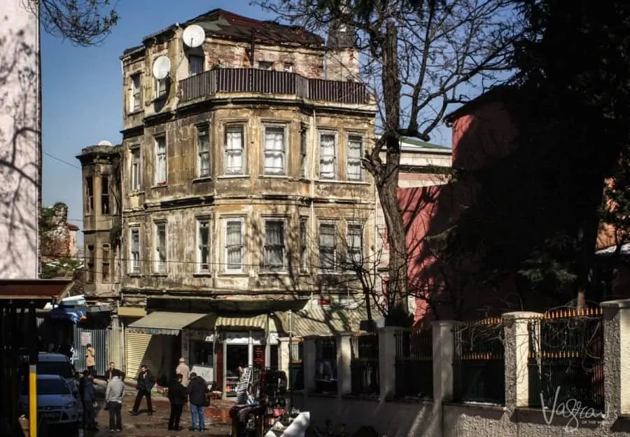 An old building with men standing around out the front chatting in the Fener District Istanbul.