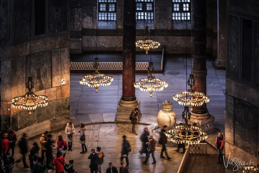 Looking down through the chandeliers at the people walking around the Hagia Sophia mosque. 