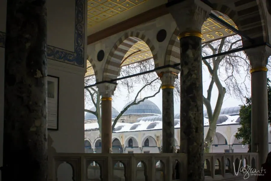 Looking through the arches of Topkapi Palace at the domes of Blue Mosque.
