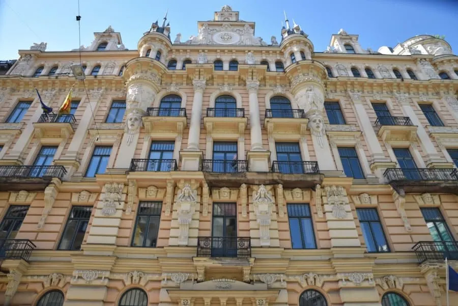 Yellow and white facade of Art Noveau building in Riga Latvia. Checking out the architecture is a great free thing to do in Riga