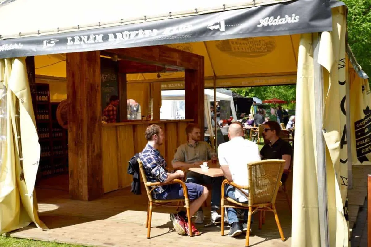 men sitting at a table drinking beer at the Latvian Beer Festival, Riga. Unusual things to do in Riga