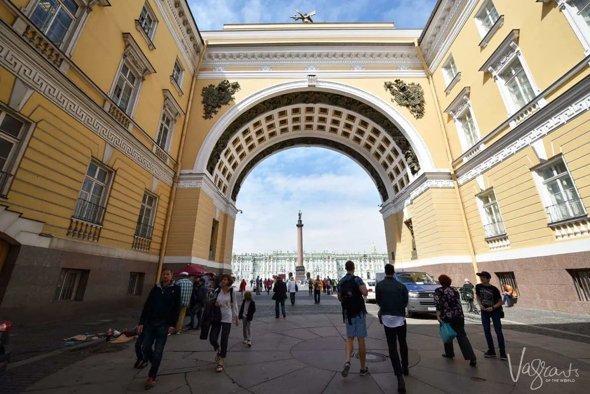 people walking under yellow archway in Moscow.  Getting around Russia is easy on a river cruise in Russia but you will need a russian visa.  We can also show you how to get a tourist visa for russia