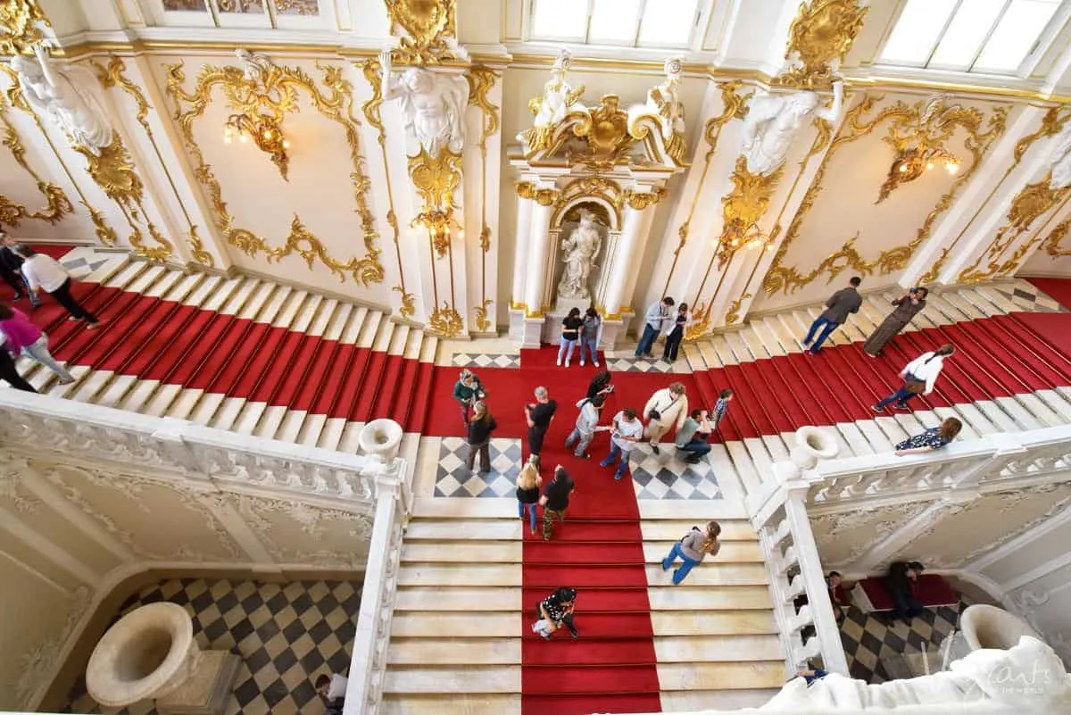 a russian river cruise shore excursion with people walking up the T shaped staircase on the red carpet.  river cruising is the best way to see russia.