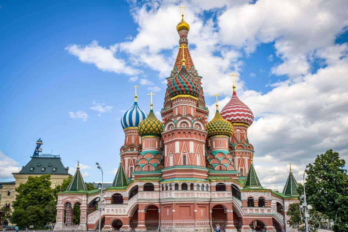 famous places in russia St Basils Cathedral colourful parapets blue sky. Don't miss out on this when moscow sightseeing