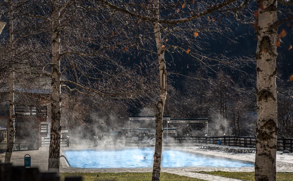 Steaming thermal swimming pool surrounded by trees in Devin Bulgaria