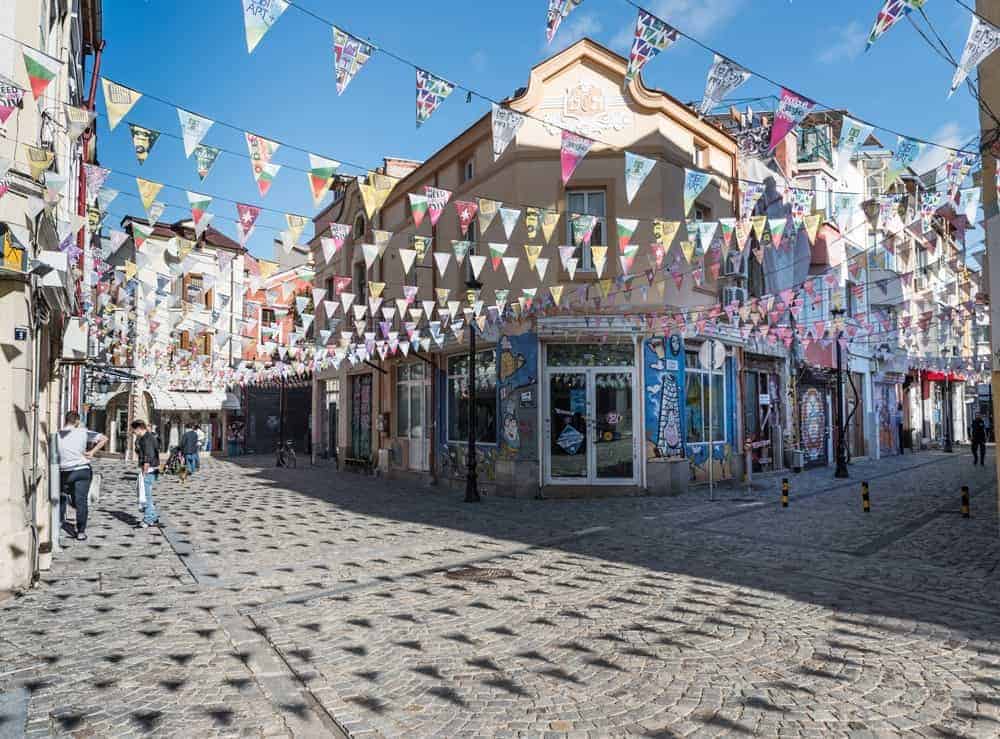 Flag buntings hanging in the street of Plovdiv Old Town.