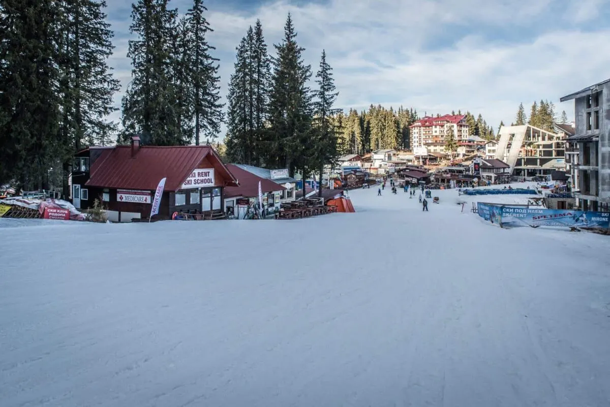 Skiers gathered outside the base station buildings at Pamporovo