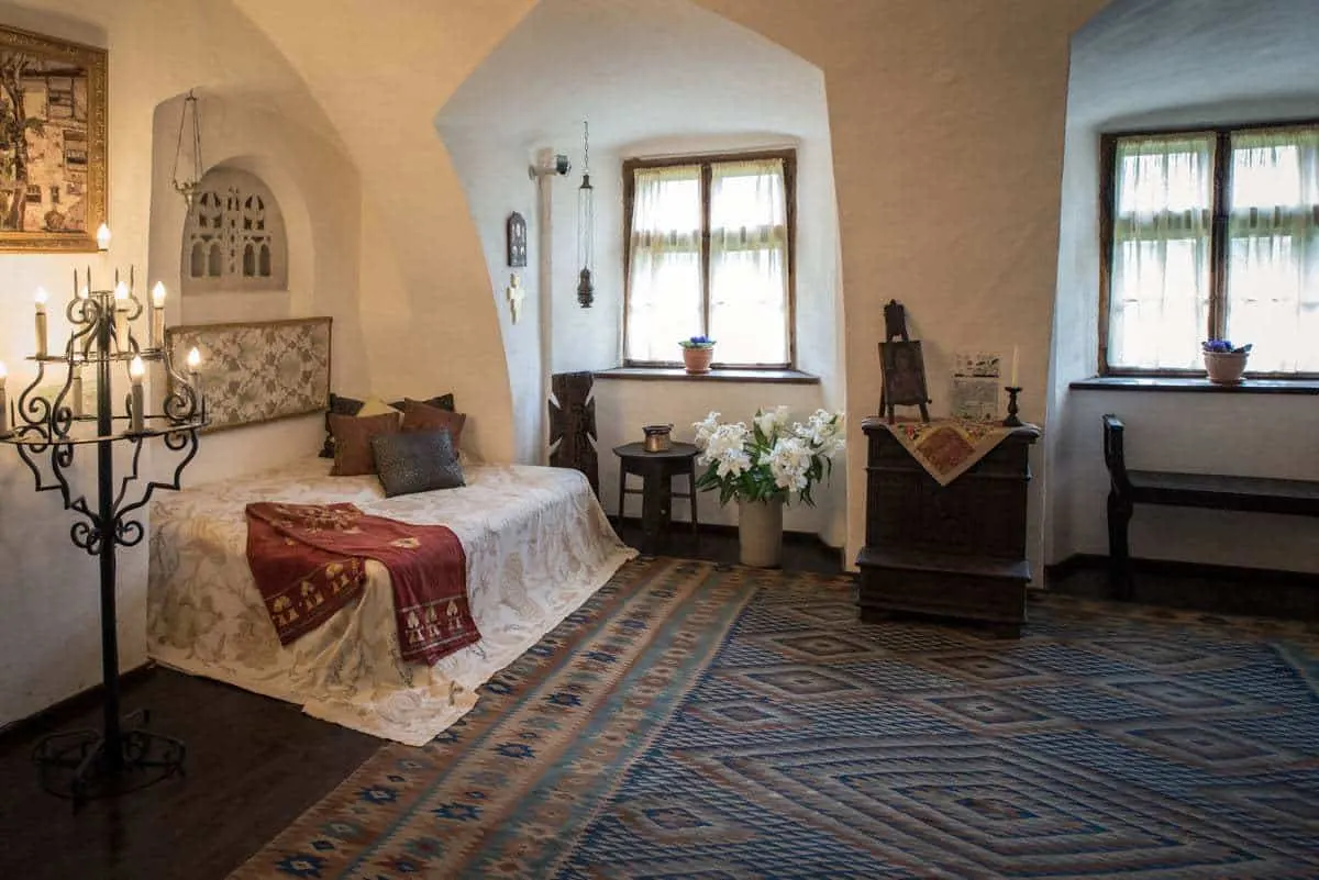 A large bedroom and candelabra inside Bran Castle Transylvania Romania. 