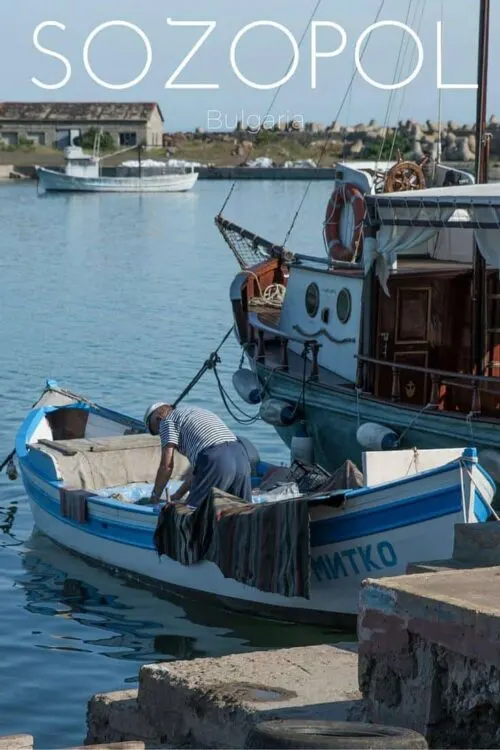 Fisherman in a blue and white boat in Sozopol Bulgaria