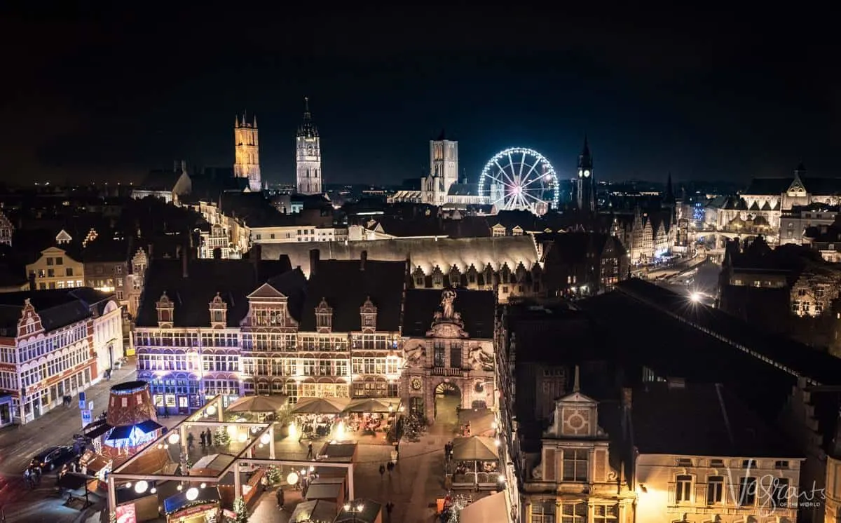 Ghent Nightlife, brightly lit markets, illuminated facades and a giant wheel in the background. This is why visiting Ghent is one of the best things to do in Belgium