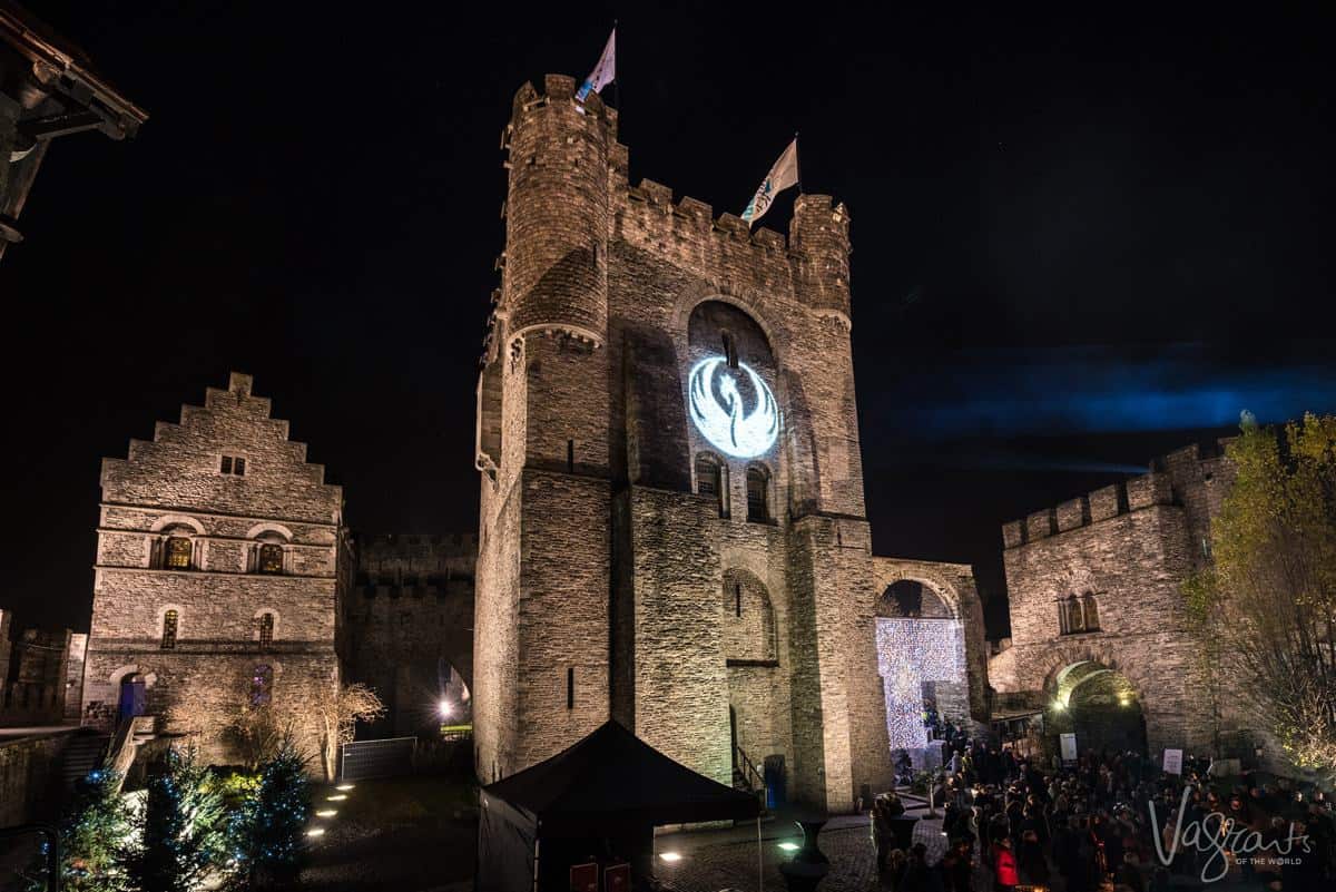 Castle of the counts Ghent Belgium at night with light show projected on the castle walls. This is why visiting Ghent is one of the best things to do in Belgium