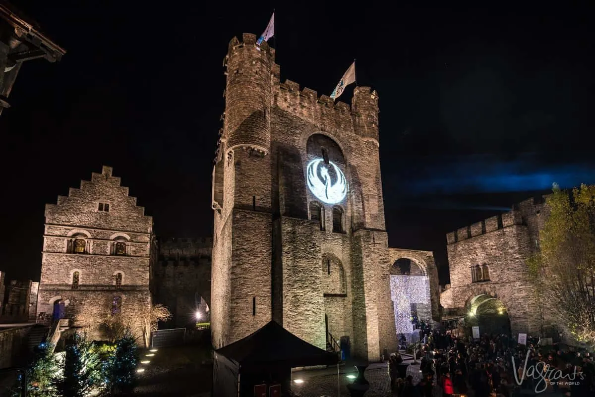 Castle of the counts Ghent Belgium at night with light show projected on the castle walls. This is why visiting Ghent is one of the best things to do in Belgium
