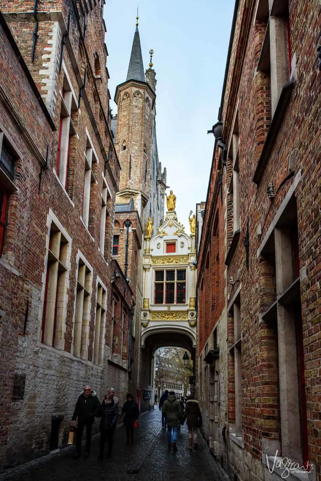 Ornate closed bridge between two buildings in old town Bruges.