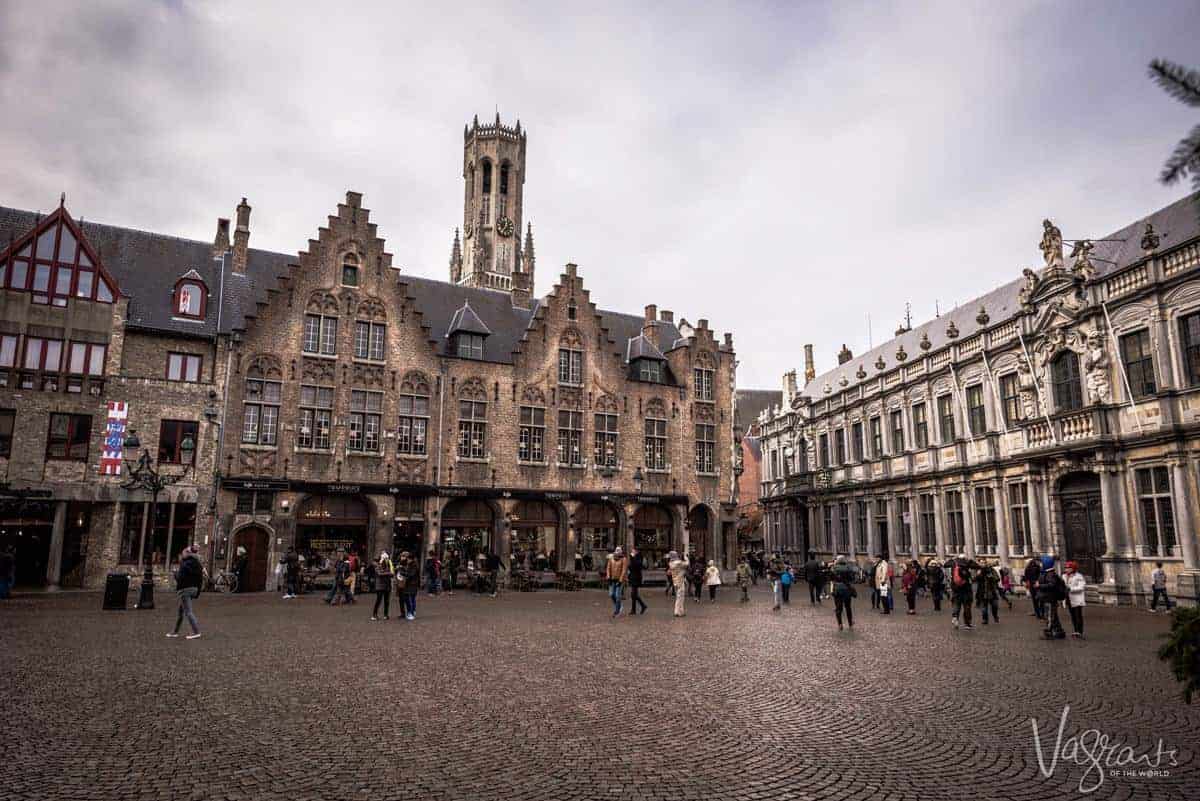 people in the medieval Market Square in Bruges. 