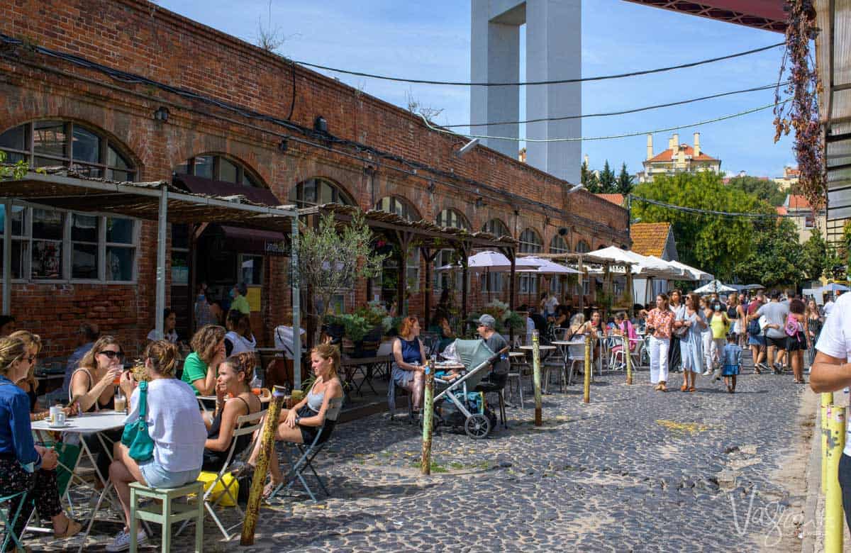 People enjoying the outdoor cafes at the LX Market in Lisbon.