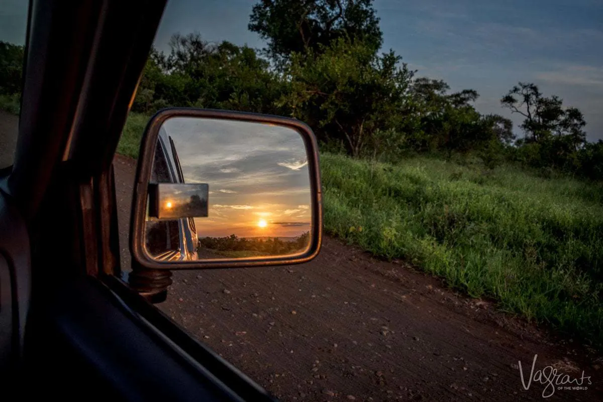 Sunsetting in the rear vision mirror of a car. 