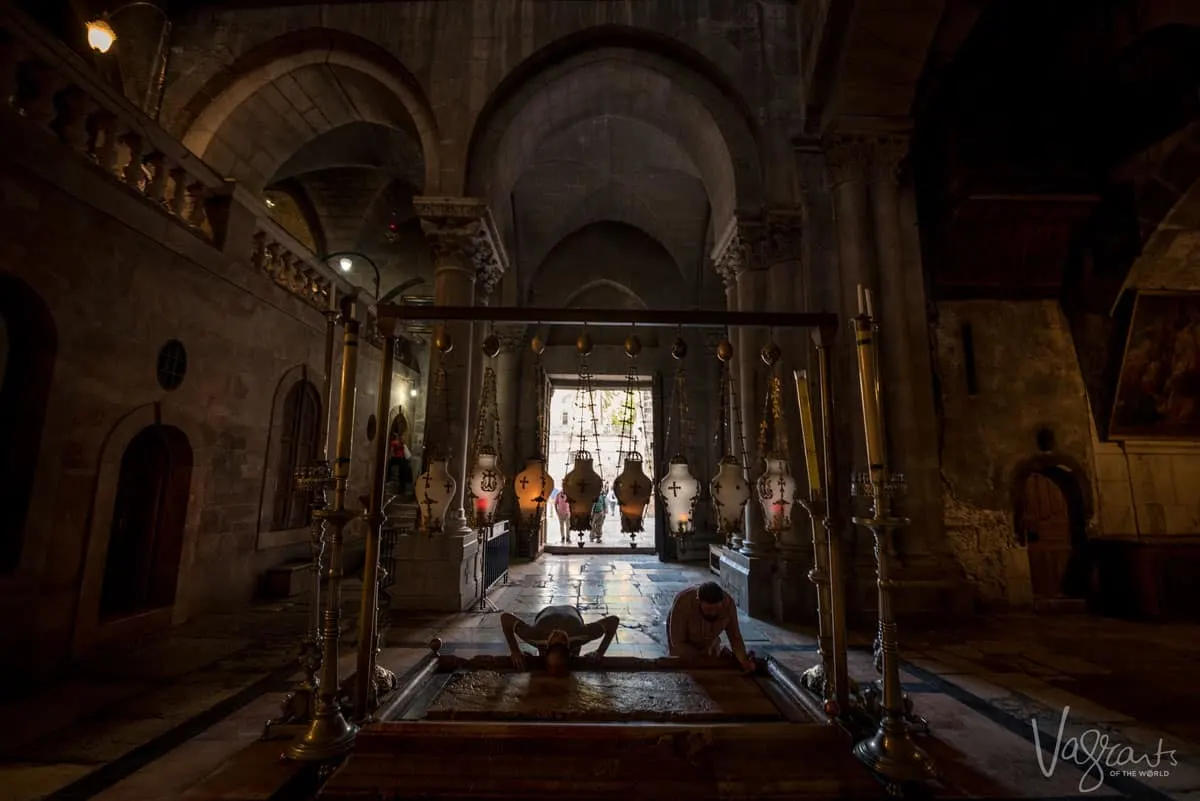 Pilgrims kiss the Stone of Anointing in the Church of the Holy Sepulchre