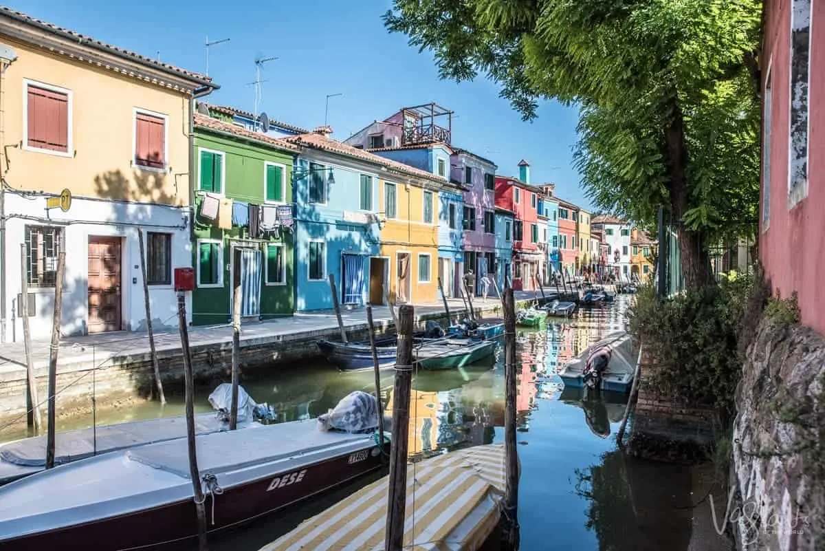 The brightly coloured houses lining a canal on Burano Island near Venice.