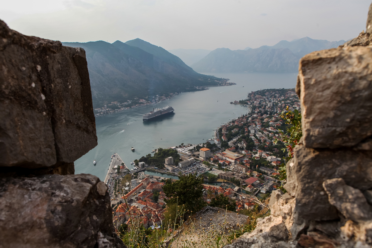 Looking down from the fortress of St john over Kotor Bay with a cruise ship in the bay.