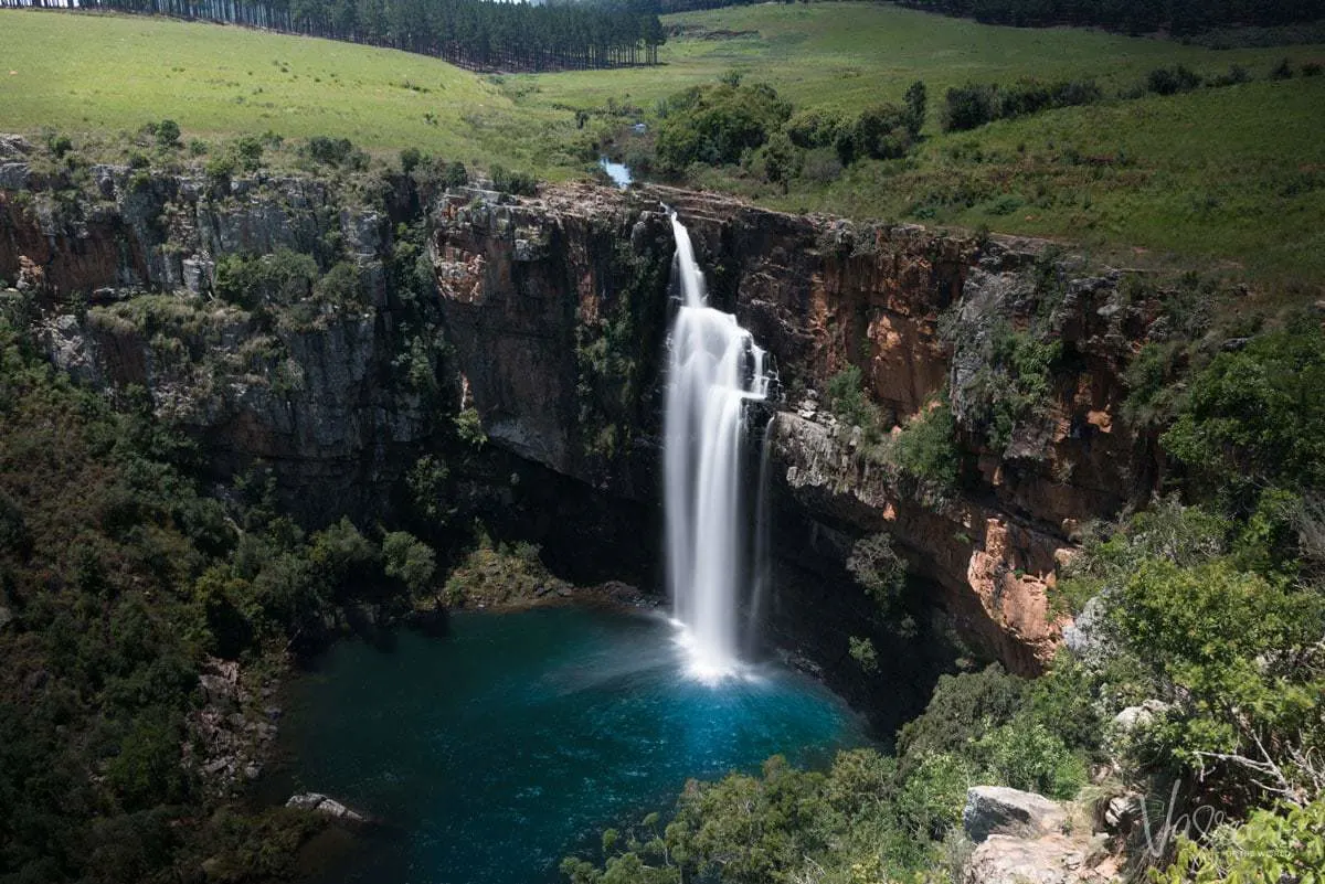 Dramatic waterfall into dark blue pond at Berlin Falls Panorama Route South Africa. Another one of the best places to explore in south africa.