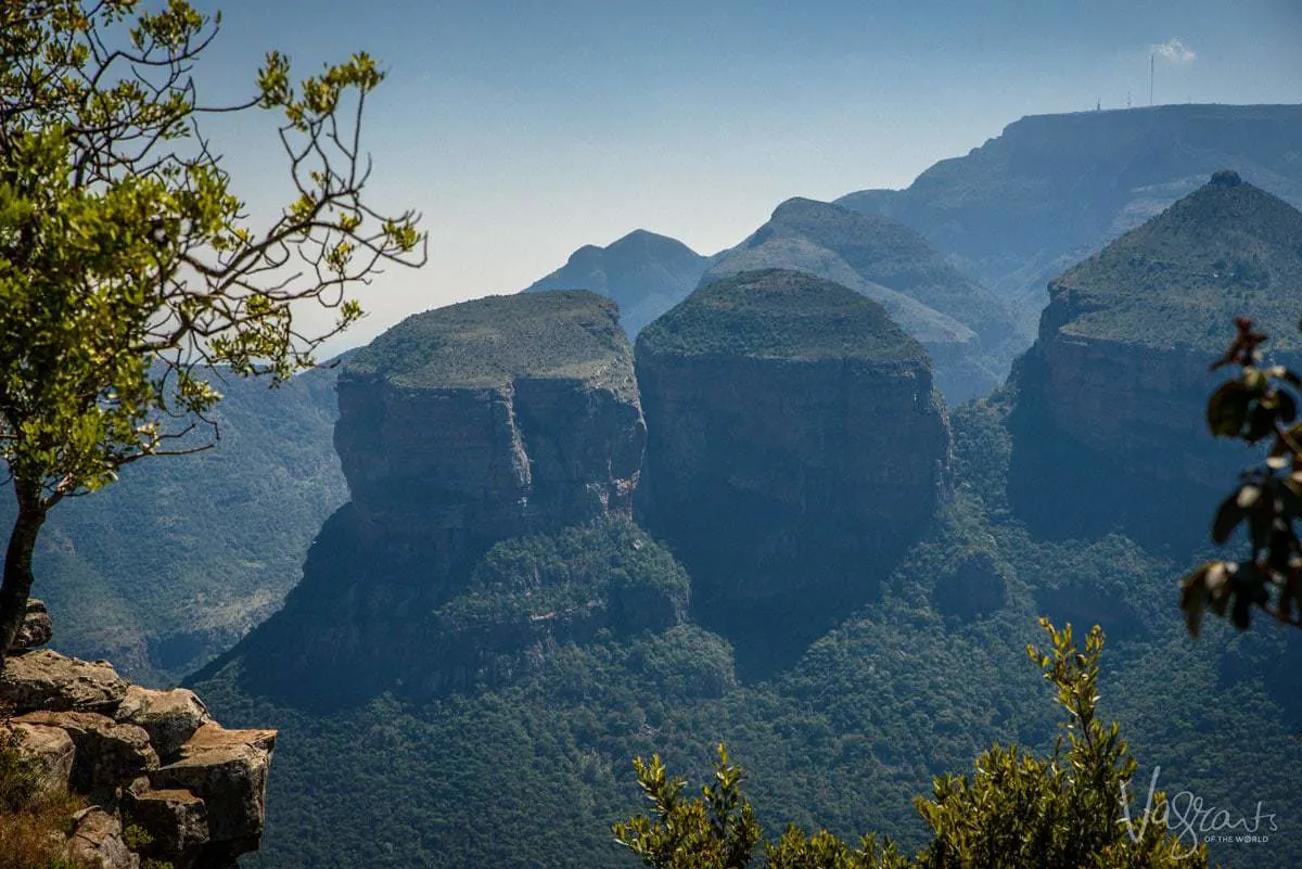 Three Rondavels covered in green vegetation and shaped like round blocks rising up from the ground. The panorama Route is one of the best places to explore in South Africa.