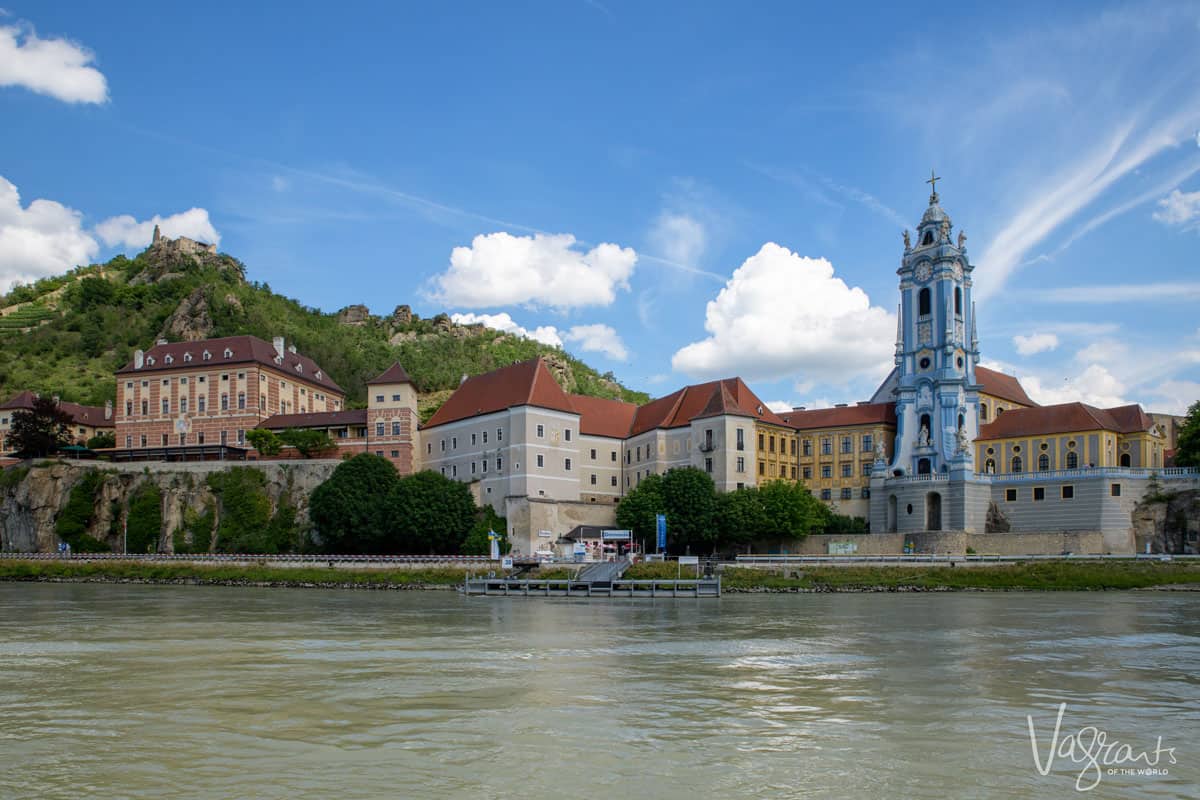 Blue church spire and small village on the bank of a river in Krems Europe. 