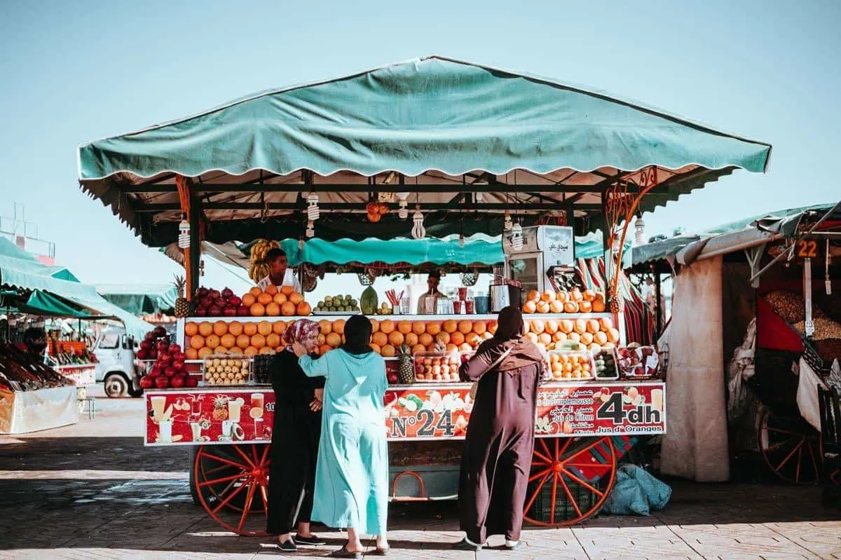 Ladies at oranage juice stand in Morocco