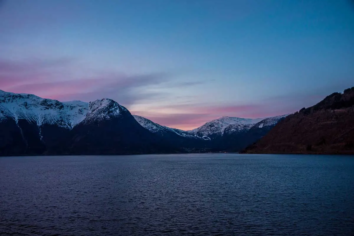 Norway Fjords with pink sky at night.