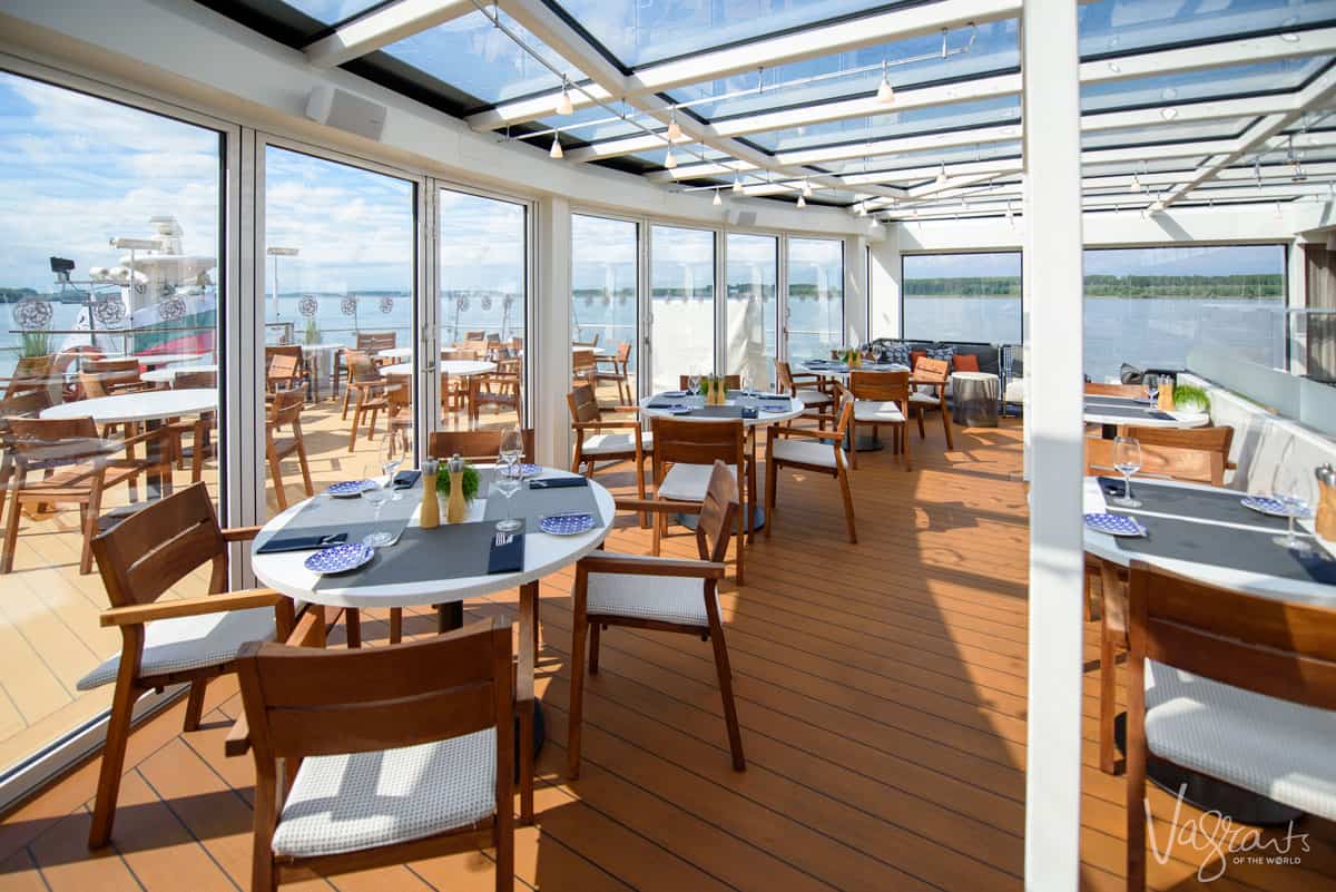A glass atrium dining area on the deck of a river cruise ship in Europe. 