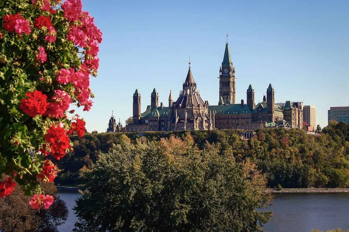 Neo-Gothic structures of Parliament Hill overlooking the Ottawa River. Parliament building Ottawa a must to include in the best things to do in Canada itinerary.