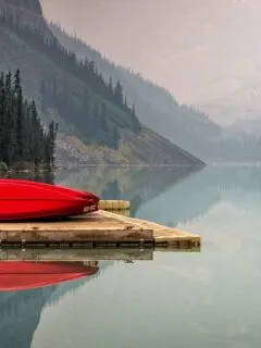Red Canoe on blue lake in banff.