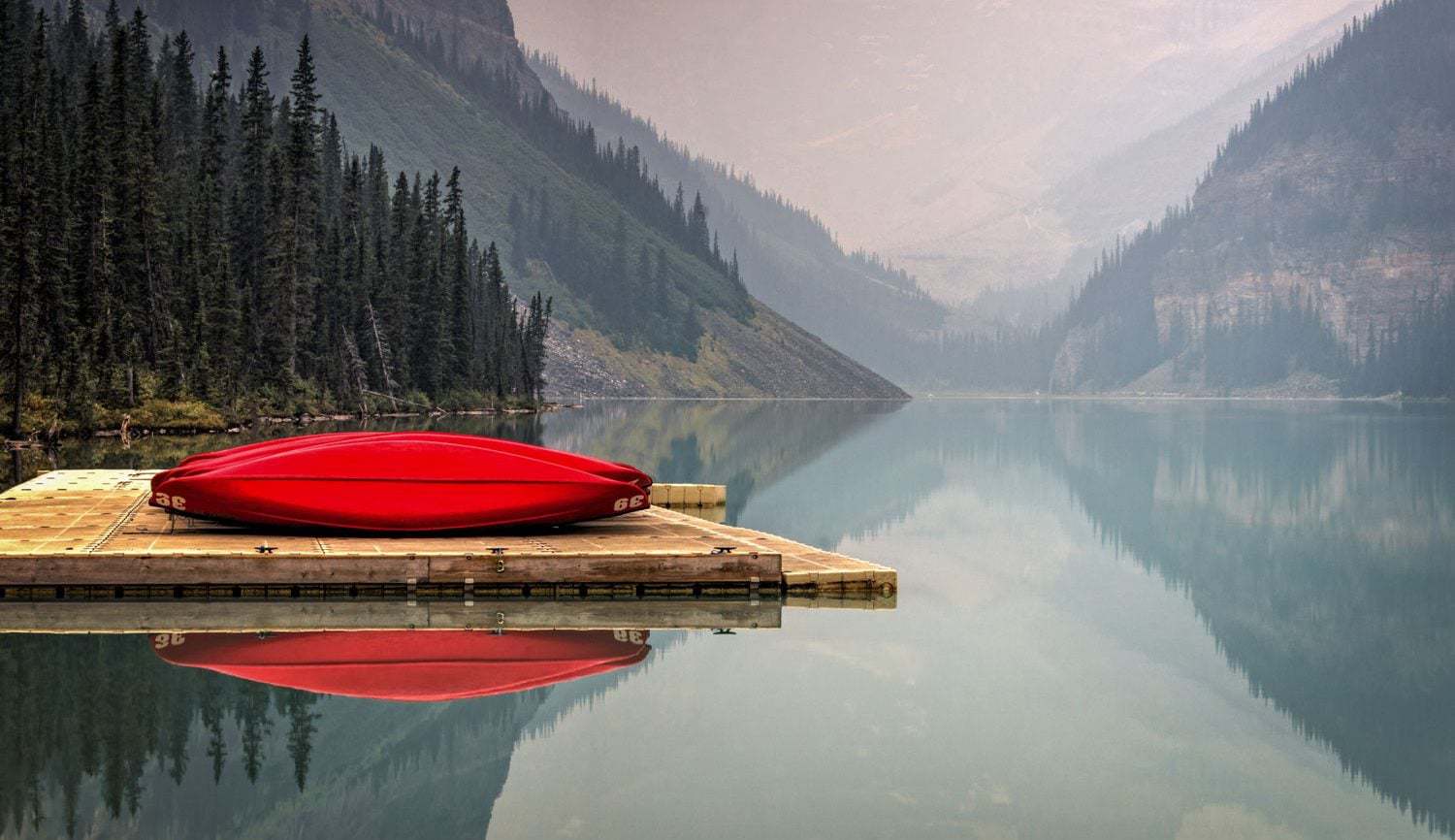 Red Canoe on blue lake in banff. 