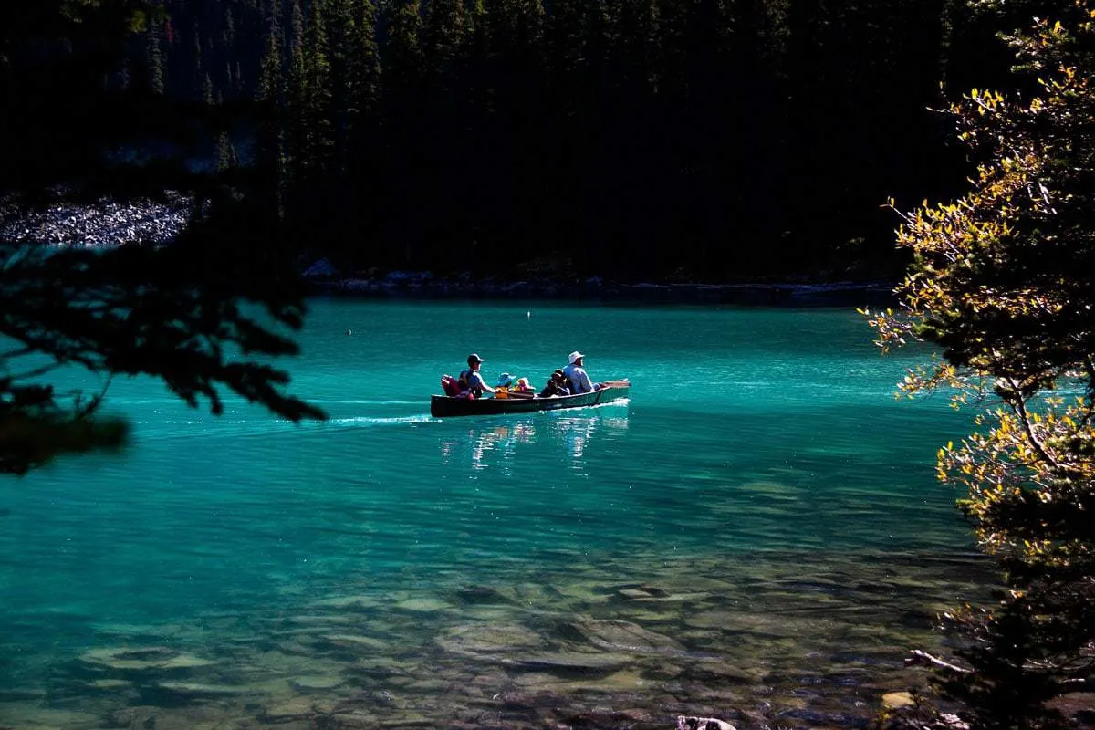 Family canoeing on Lake Louise in Banff.