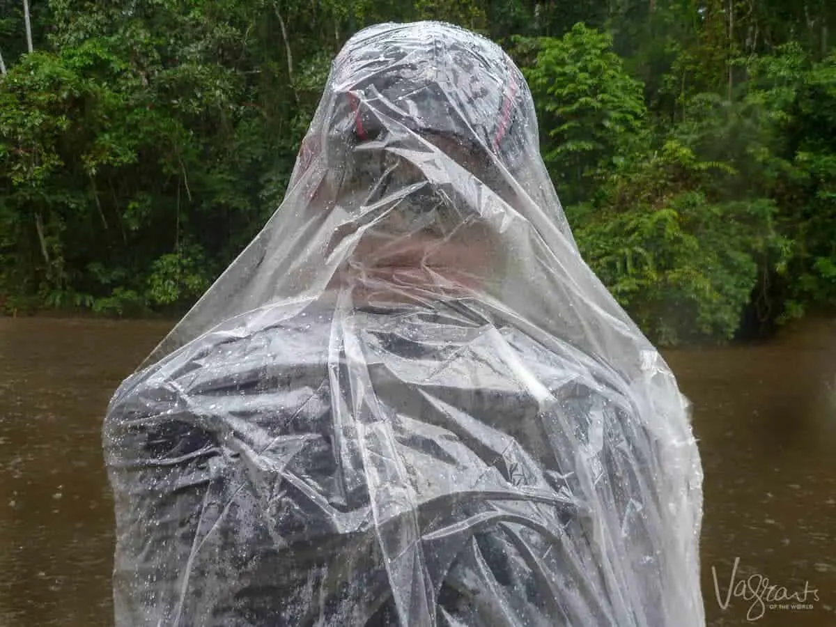 Man in poncho in rain downpour