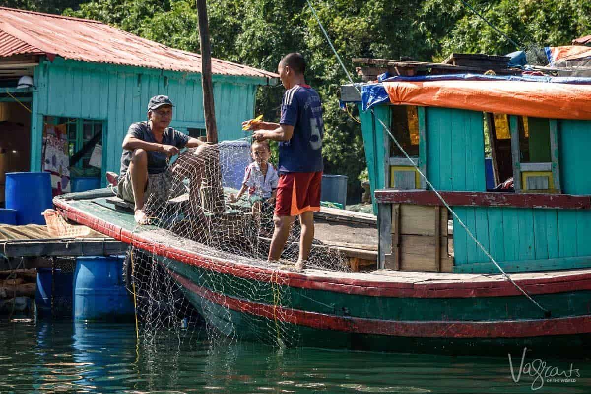 Fisherman mending nets- Cua Van Village in Halong Bay