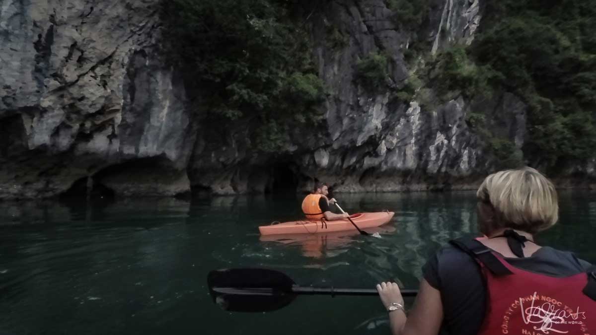 A man and a woman Kayaking in Halong Bay.