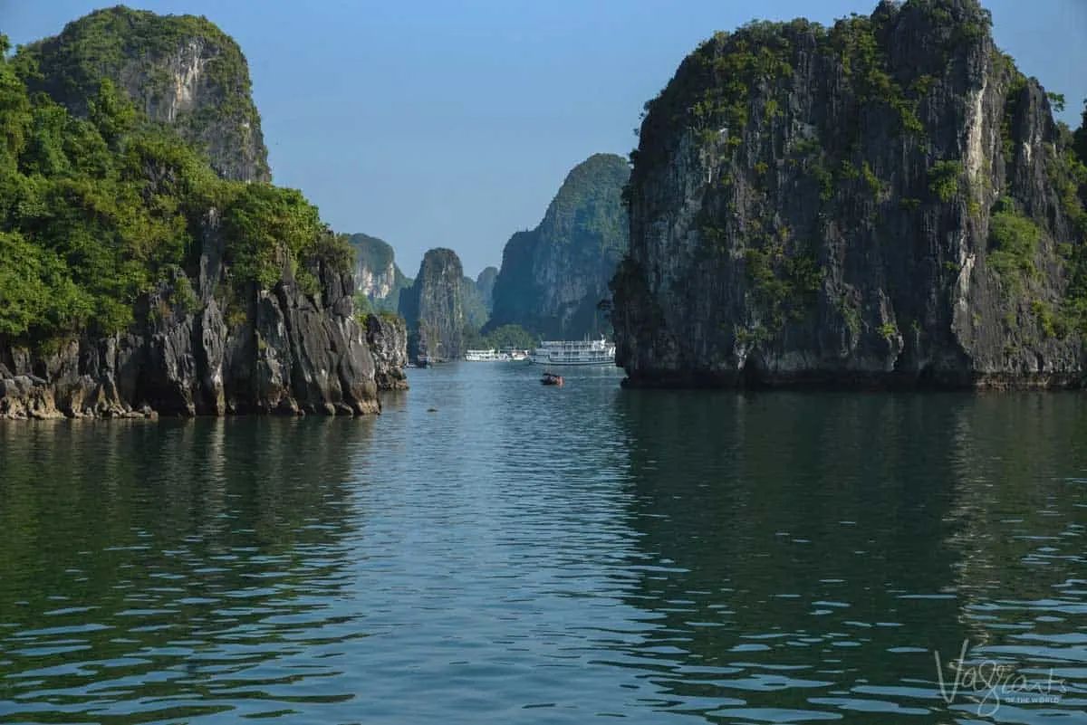 Junk boats on anchor surrounded by the iconic Halong Bay islands. 